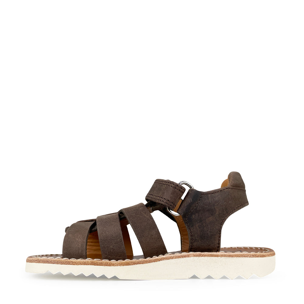 Brown sandal on white sole