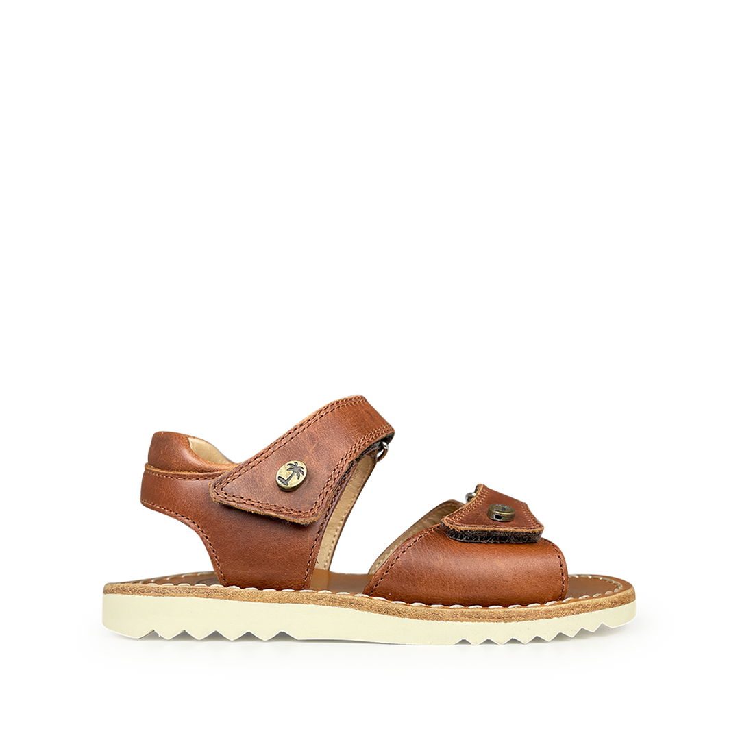 Brown sandal on white sole