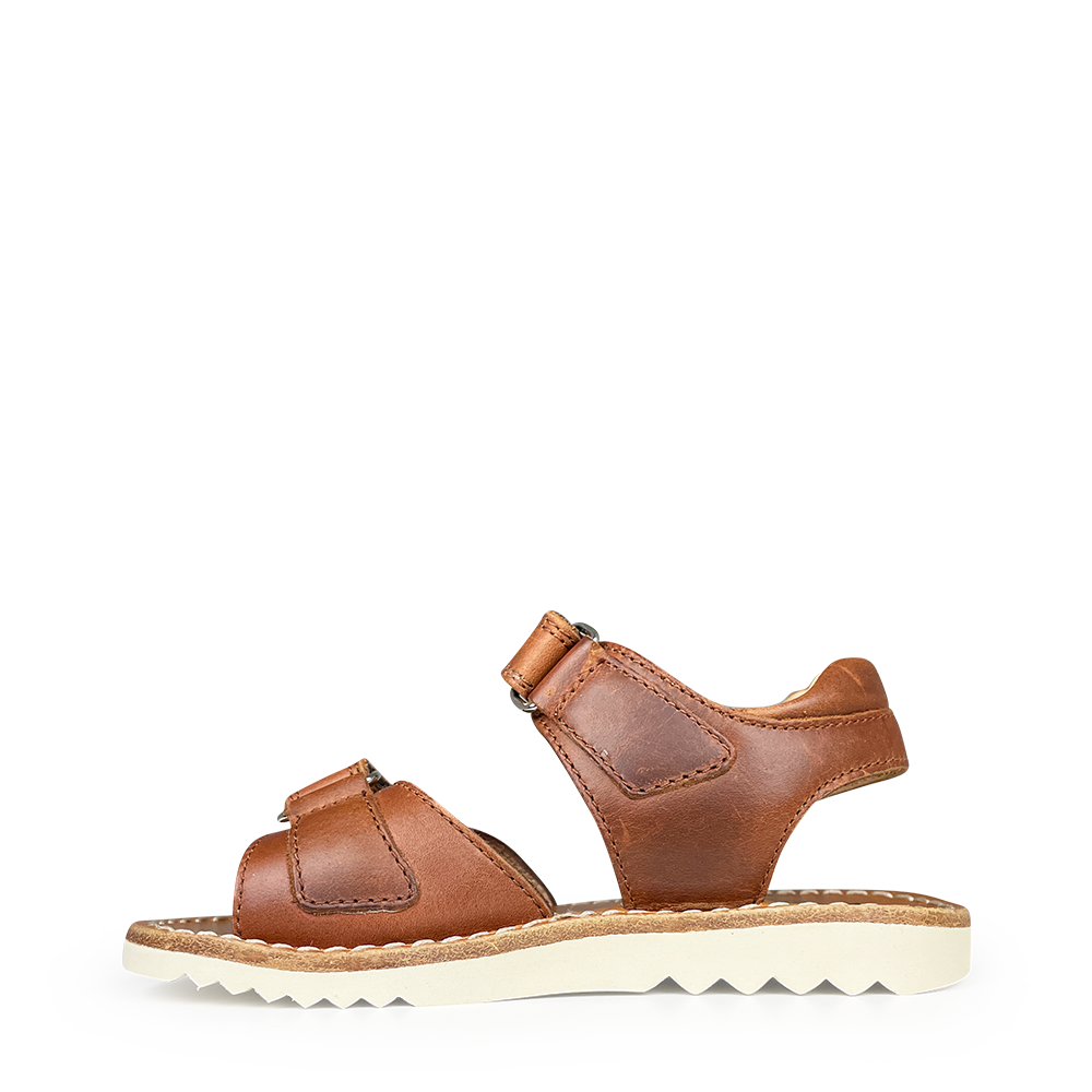 Brown sandal on white sole