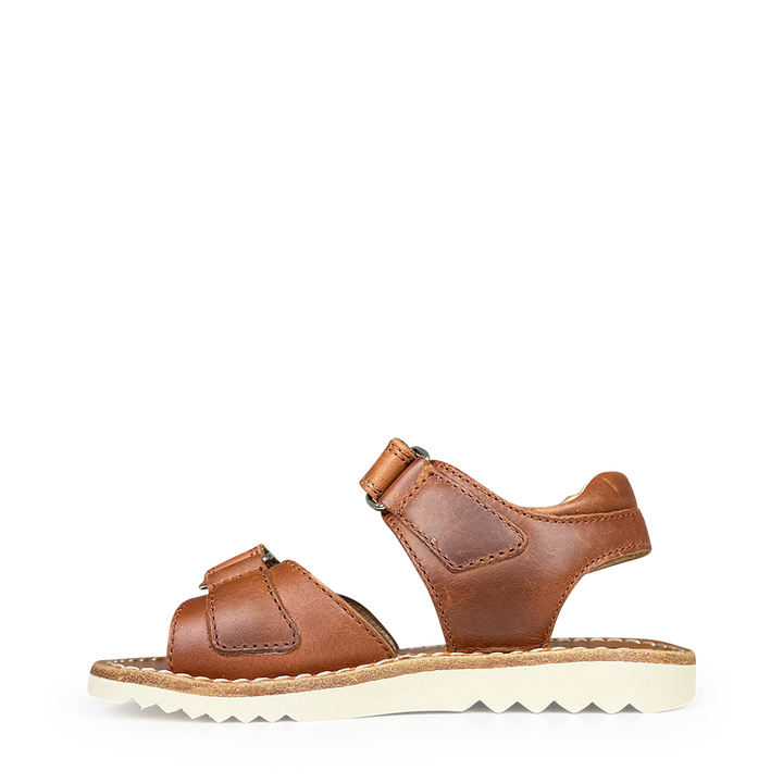 Brown sandal on white sole