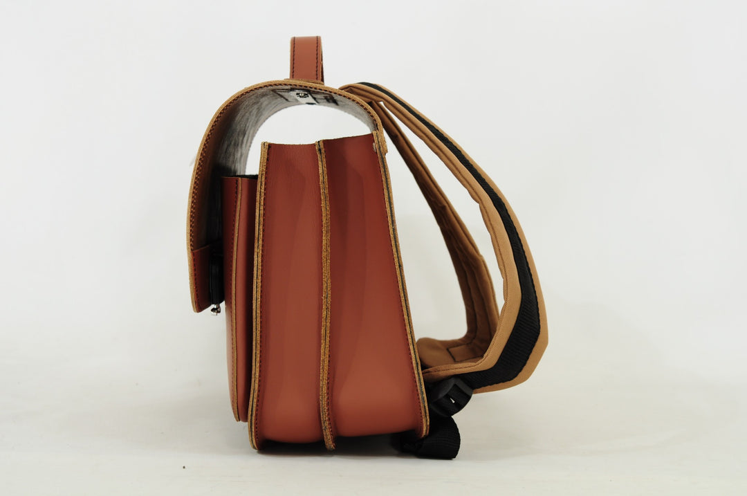 Cognac leather dino book bag with magnetic closure